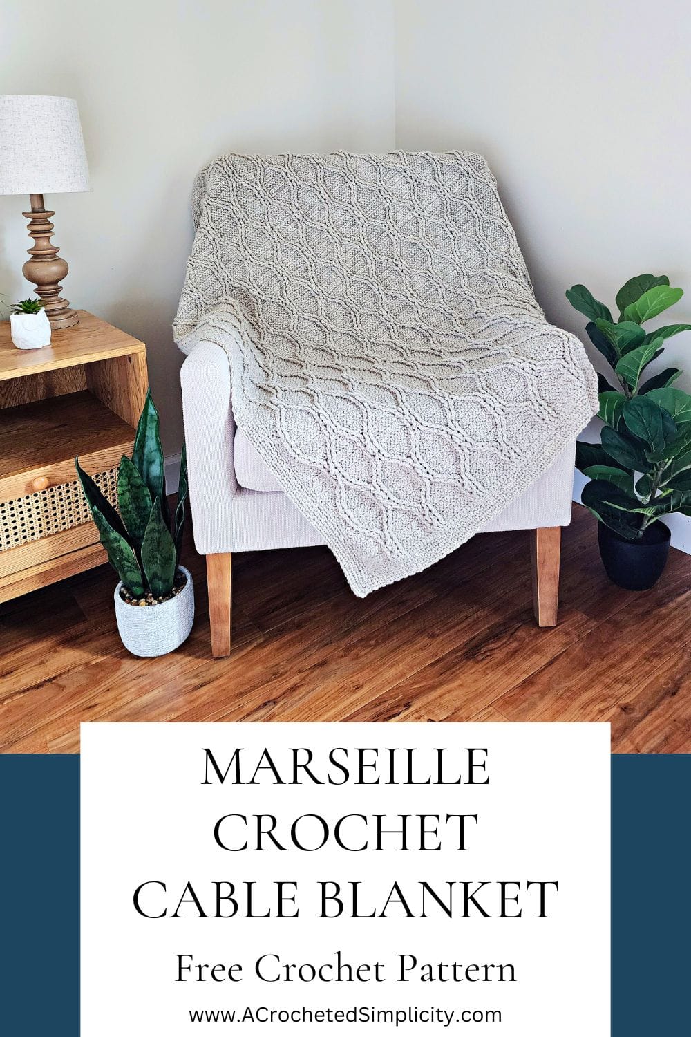 Grey crochet cable throw draped across a small chair by small wood table.