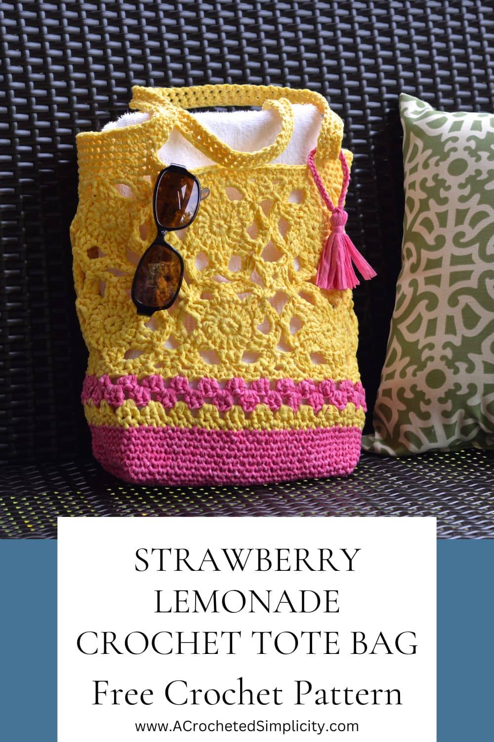 Yellow and bright pink motif crochet tote bag with a pink tassel sitting on a porch swing.