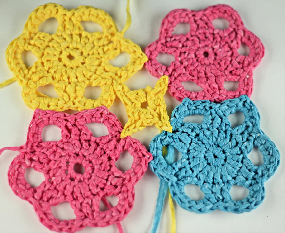 Four crochet motifs joined to form a square with a small star motif in the center.