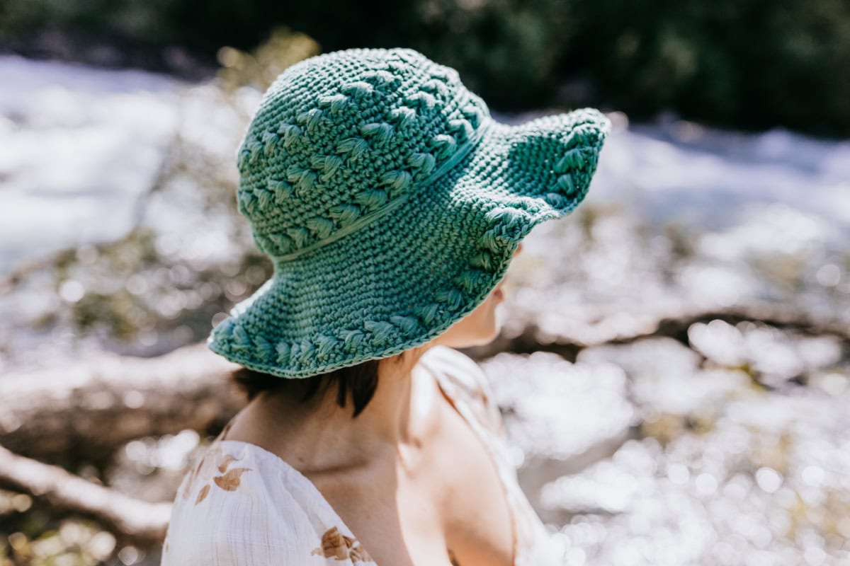 Blue green crochet sun hat with puff stitches.