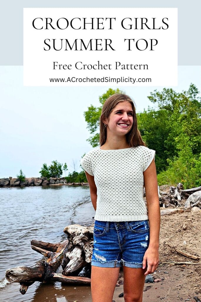 Girls crochet top for summer in cream colored cotton yarn being modeled by a young girl.