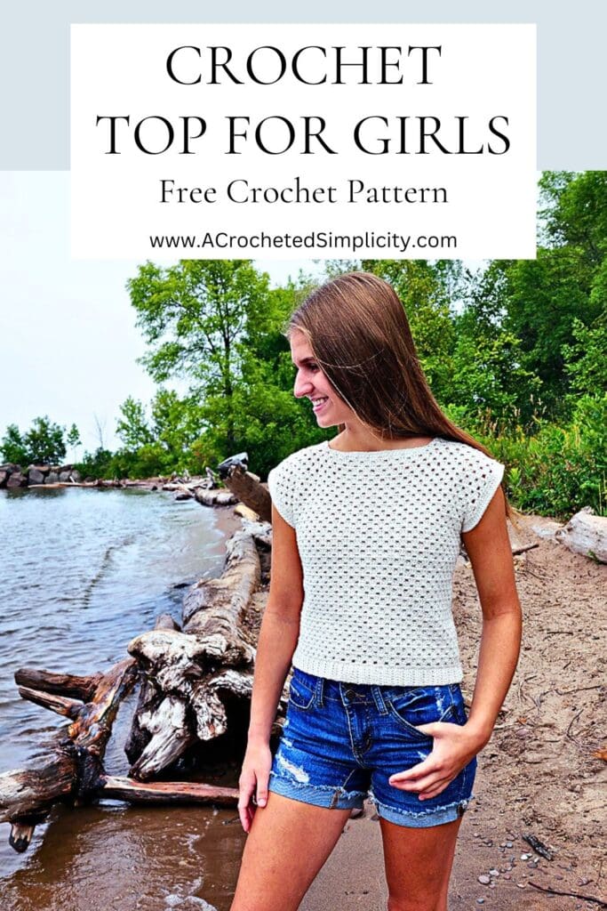 Teenager standing on a beach wearing a crochet top for girls for summer.