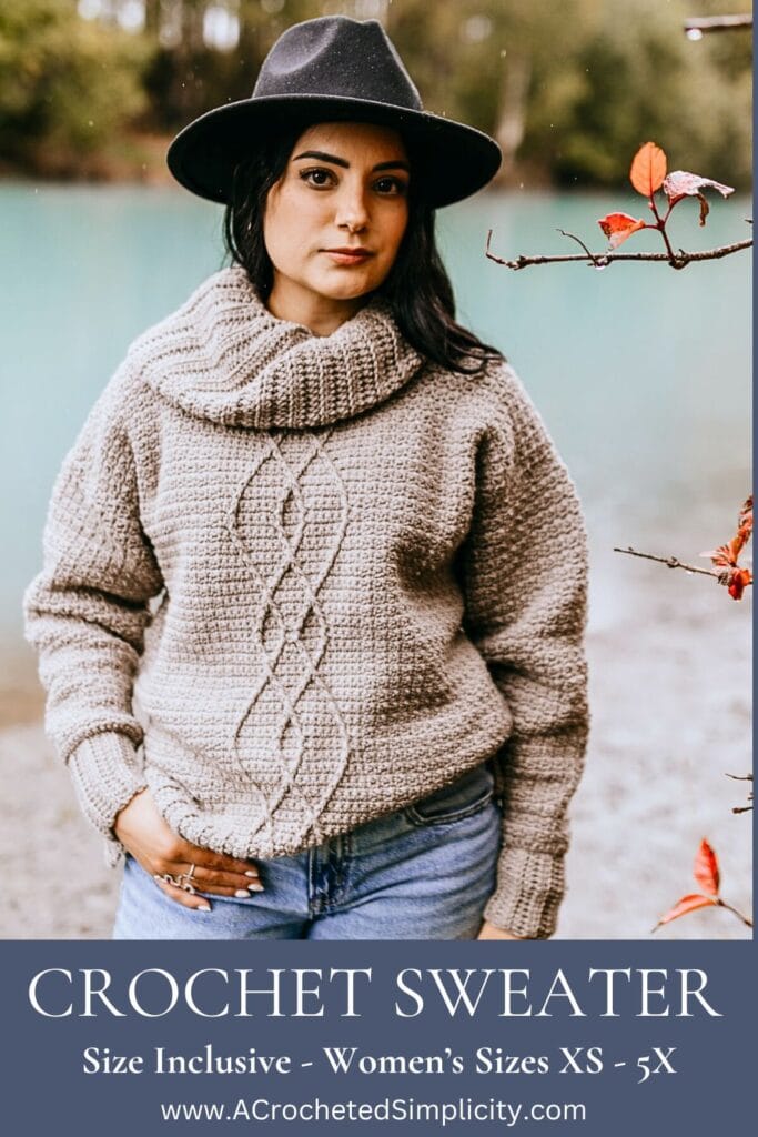 Woman wearing a beige cable crochet sweater and black hat.