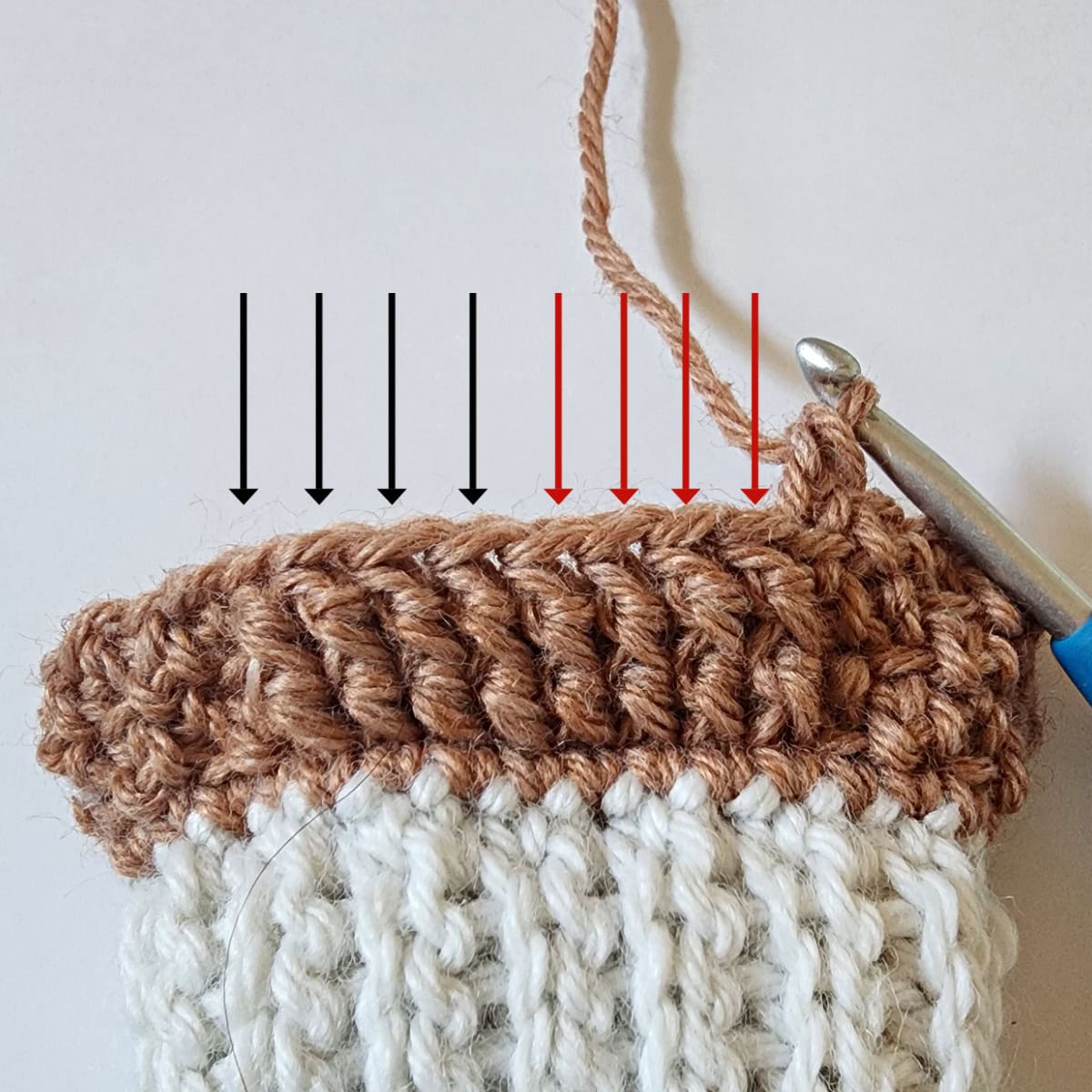 Eight front post double crochet stitches with arrows pointing to them for a cable twist.