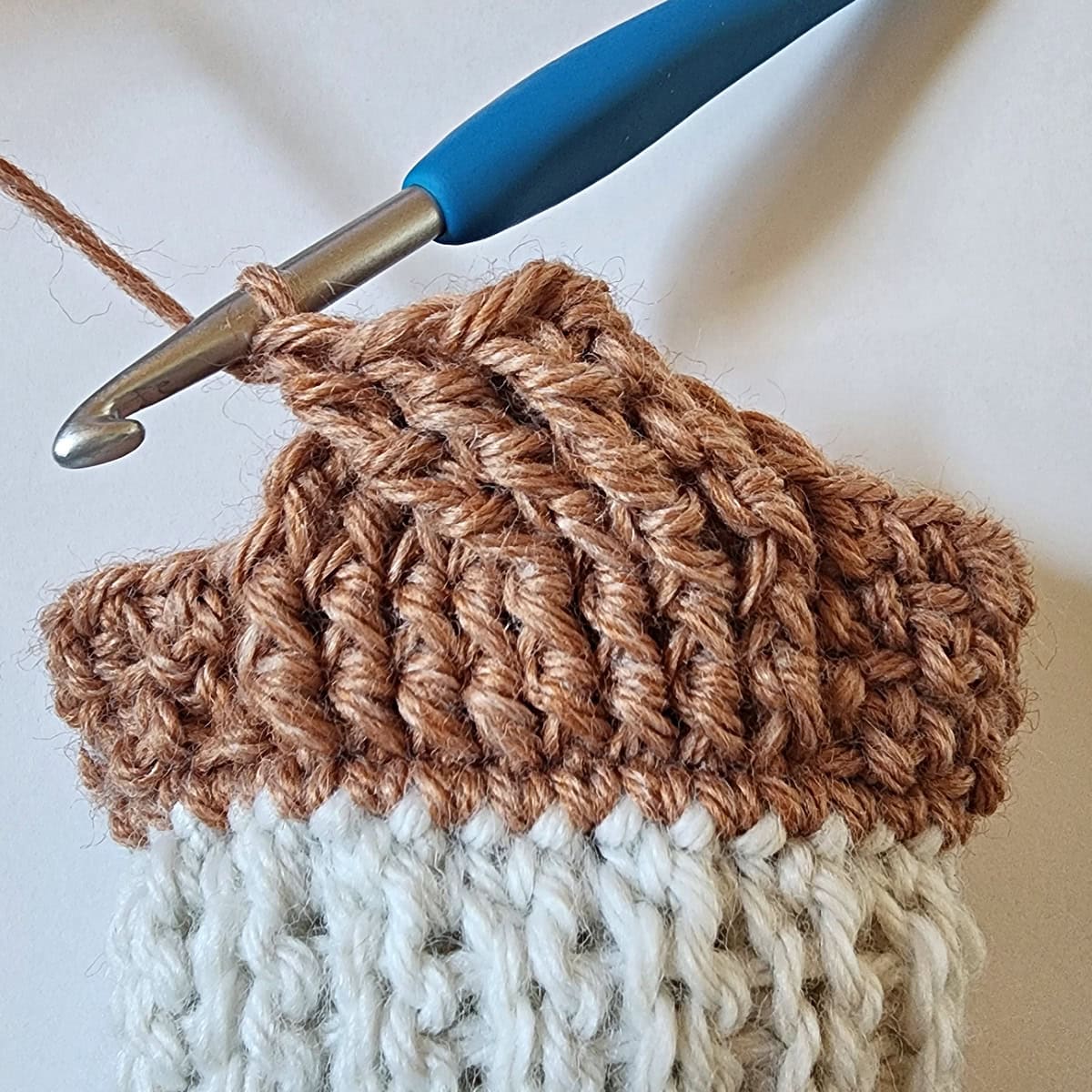 An eight strand crochet cable twist is shown complete.