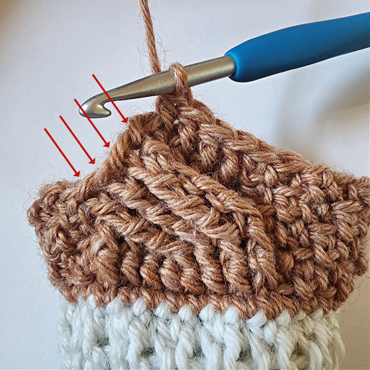 The first four fpdc worked around the cable twist and black arrows pointing to the next four post stitches.