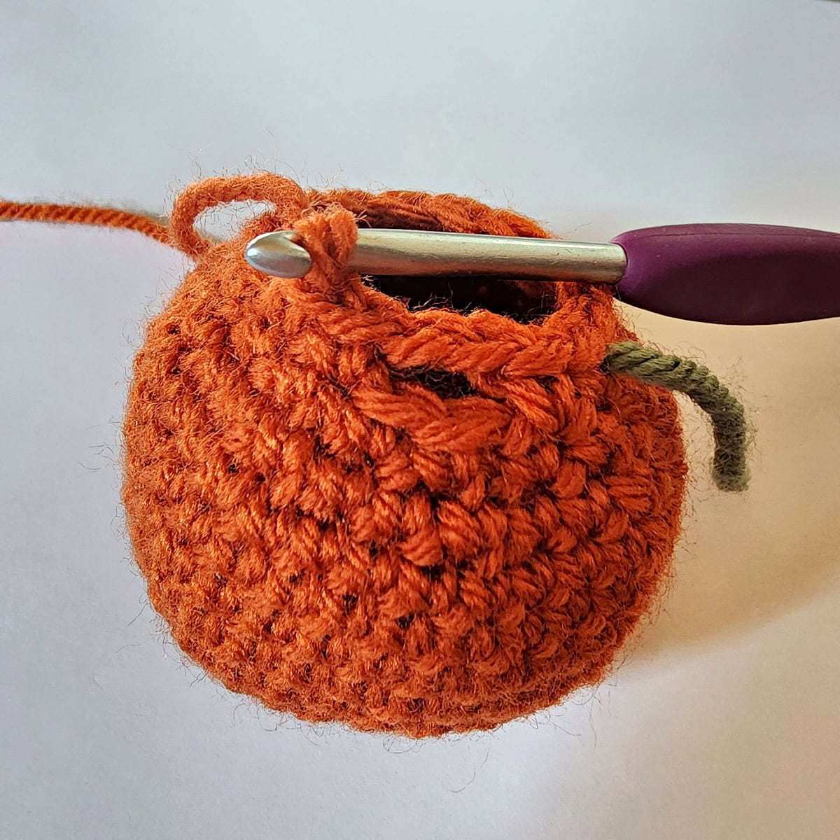 A close-up to show the chain spaces in the last round of the crochet pumpkin pattern.