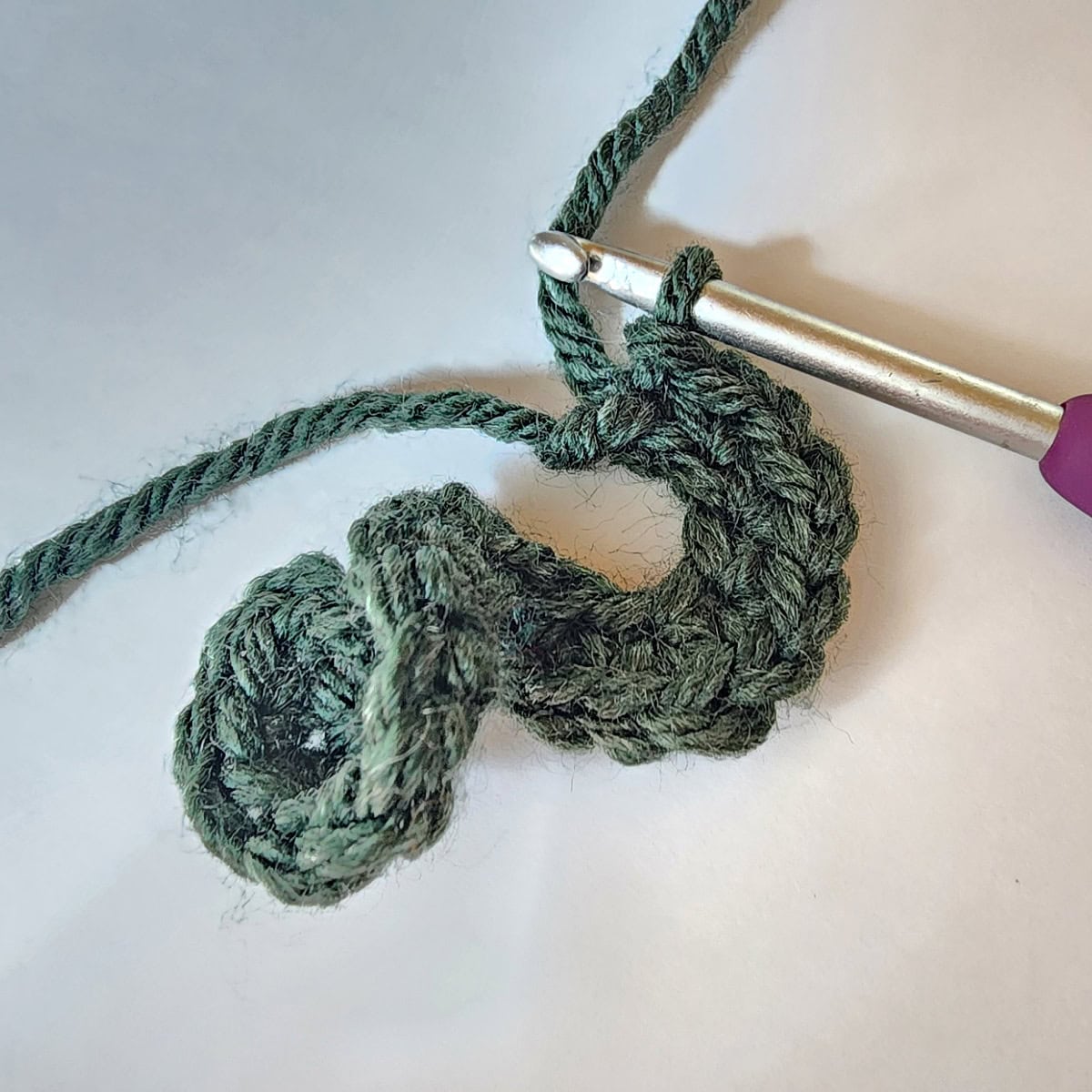 Curly part of a crochet pumpkin tendril.