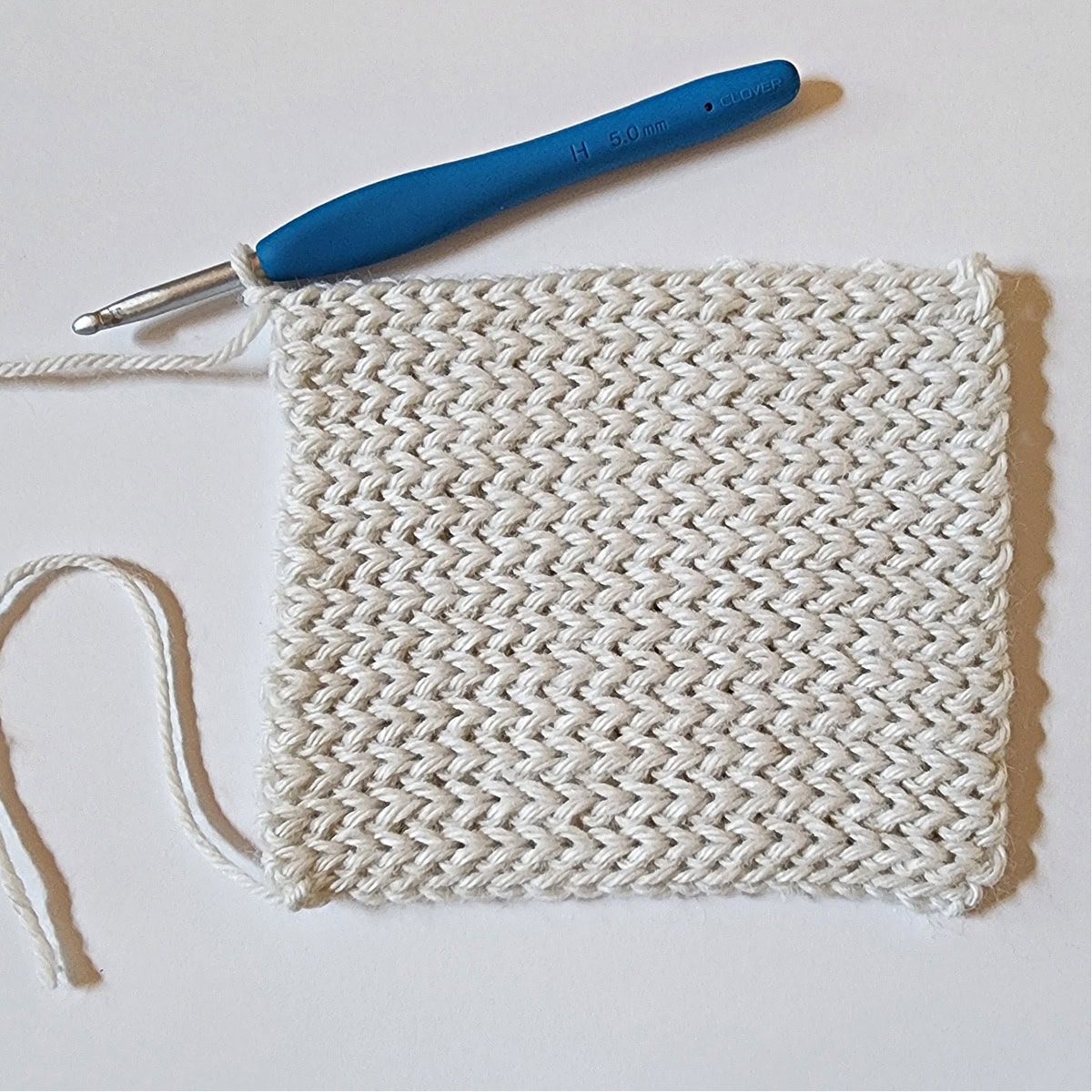 Flat square made of back loop only slip stitch to create a crochet mitten cuff.