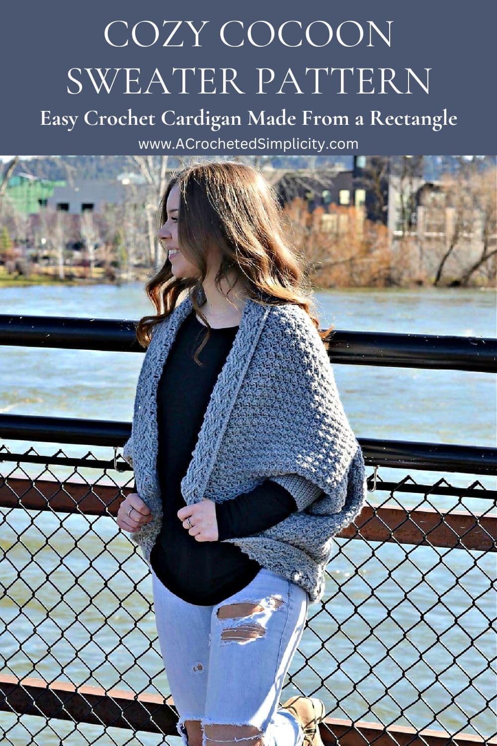 A girl modeling a cozy cocoon sweater in grey.