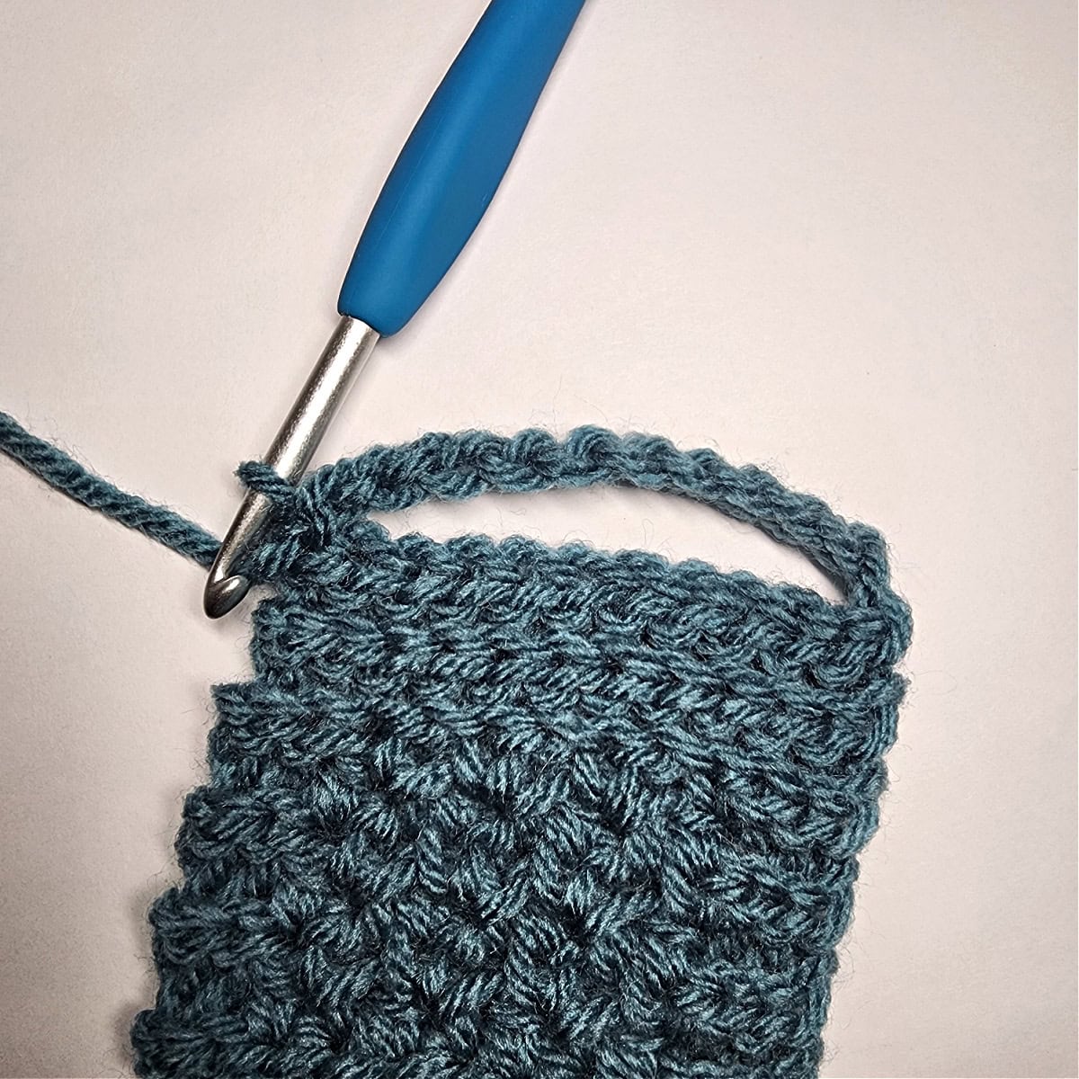 The chain is slip stitched to the last row to create a loop for the mug handle.