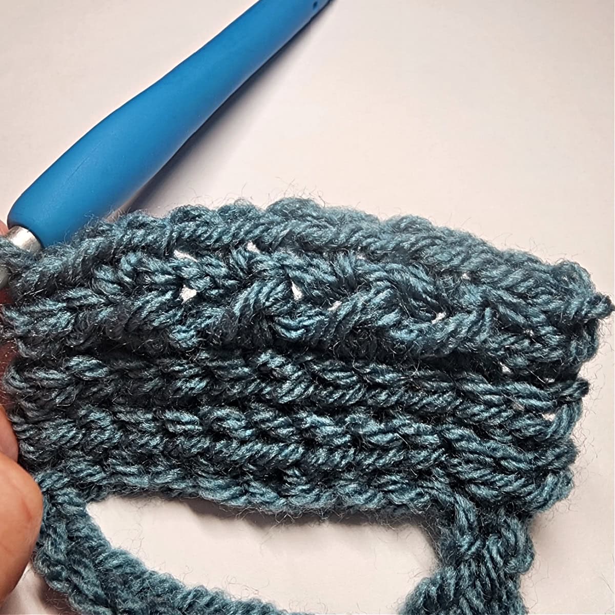 Close up photo of crochet crunch stitch pattern.