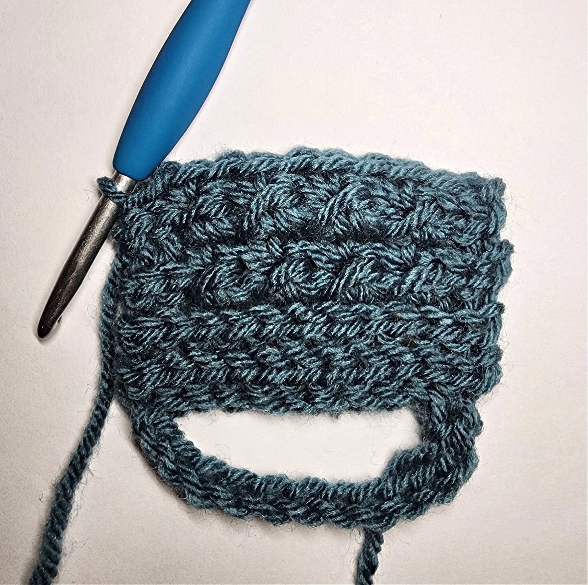 Five rows of the crochet crunch stitch attached to crochet ribbing.