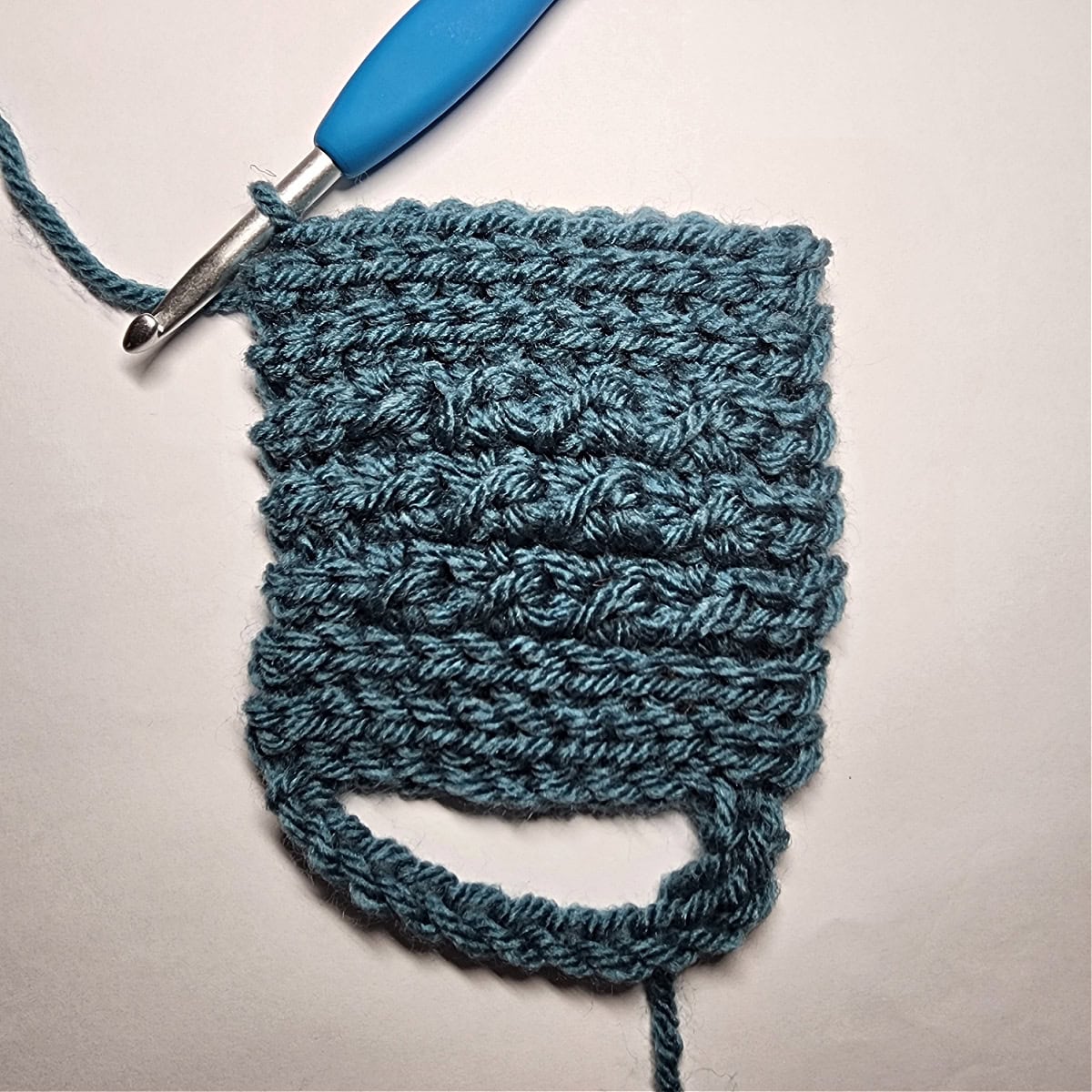 Alternating sections of knit look ribbing and the crochet crunch stitch.