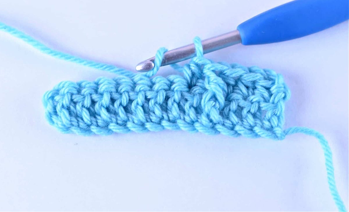 A half double crochet (hdc) worked in the stitch following a fpdc.