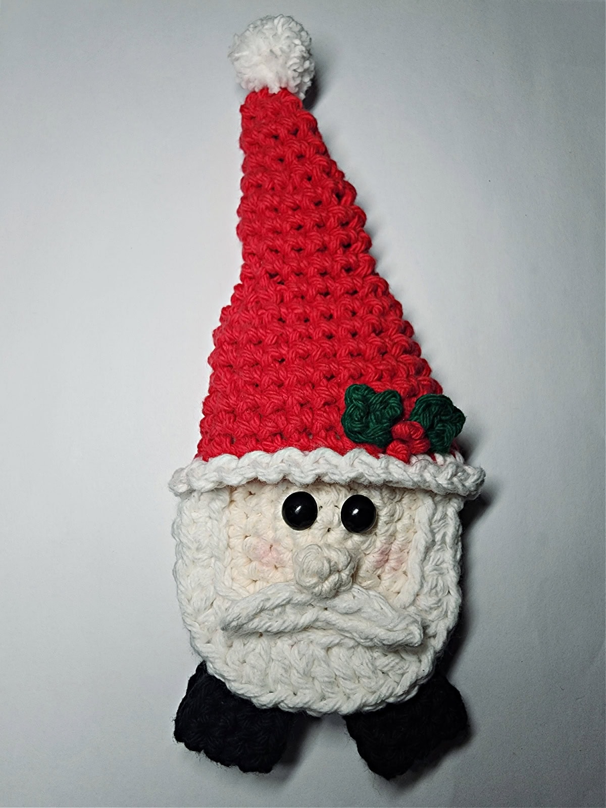 Crochet Santa with hat sticking up in the air before finishing.