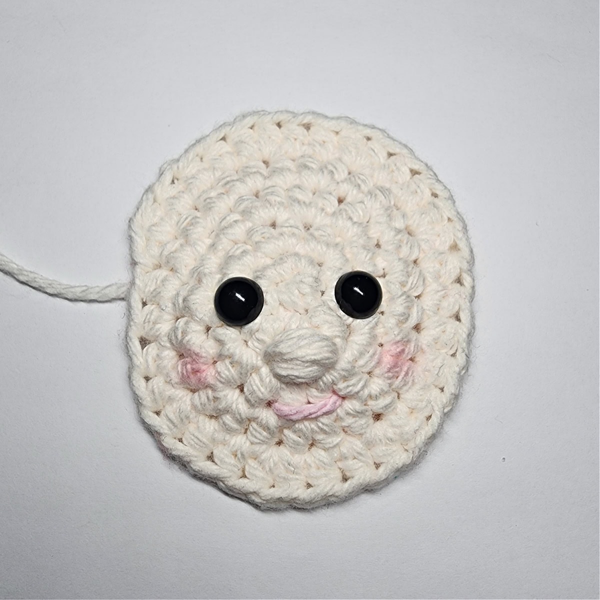 How to add pink rosy cheeks on a crochet elf ornament with blush.