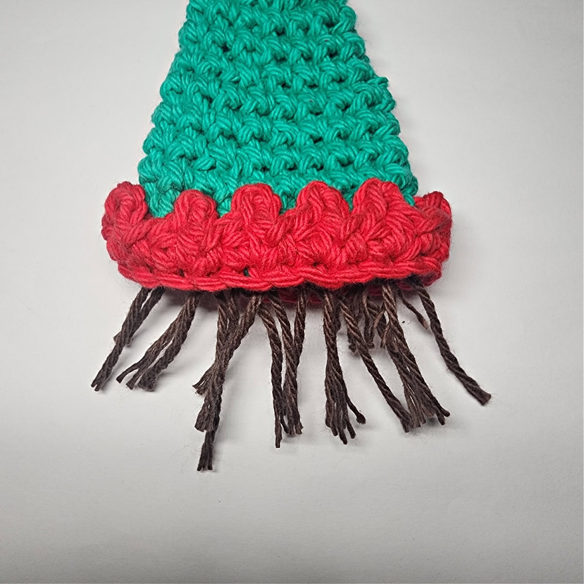 Trim the brown yarn that was attached to the elf hat.