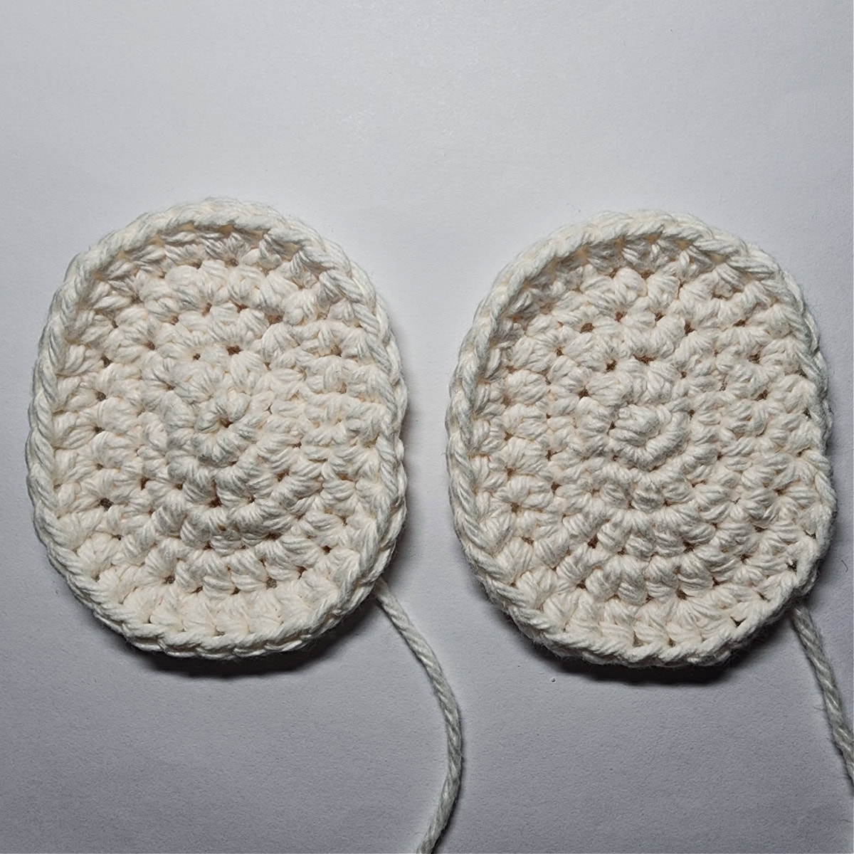 Two cream colored ovals that become the elf's head.