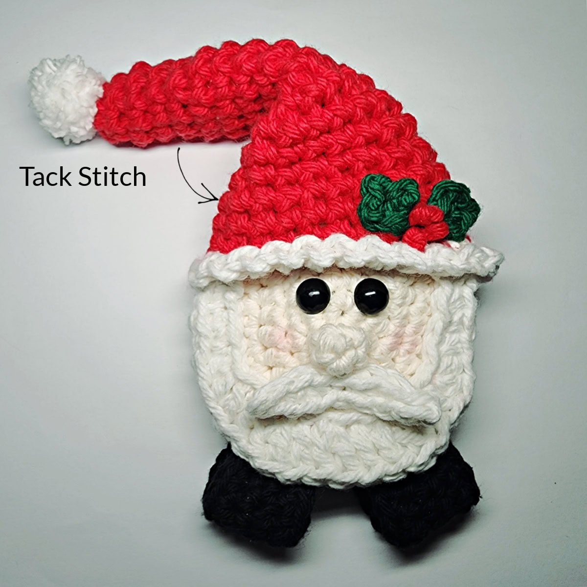 Santa crochet ornament tutorial that shows how to bend the tip of the hat down to complete.