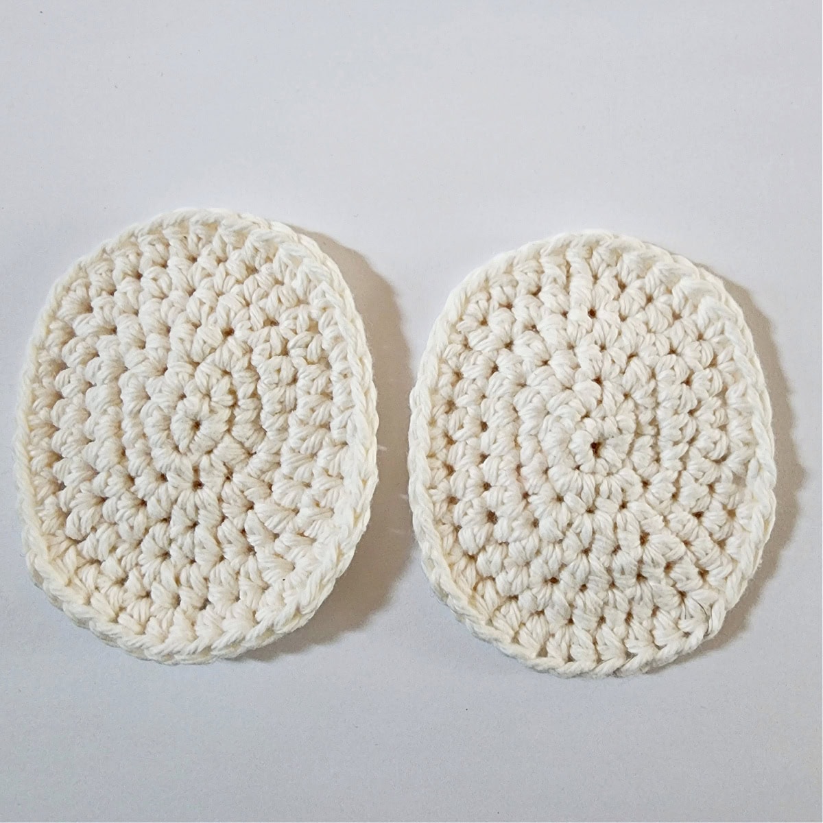 Two cream colored crochet ovals to make a Santa face.