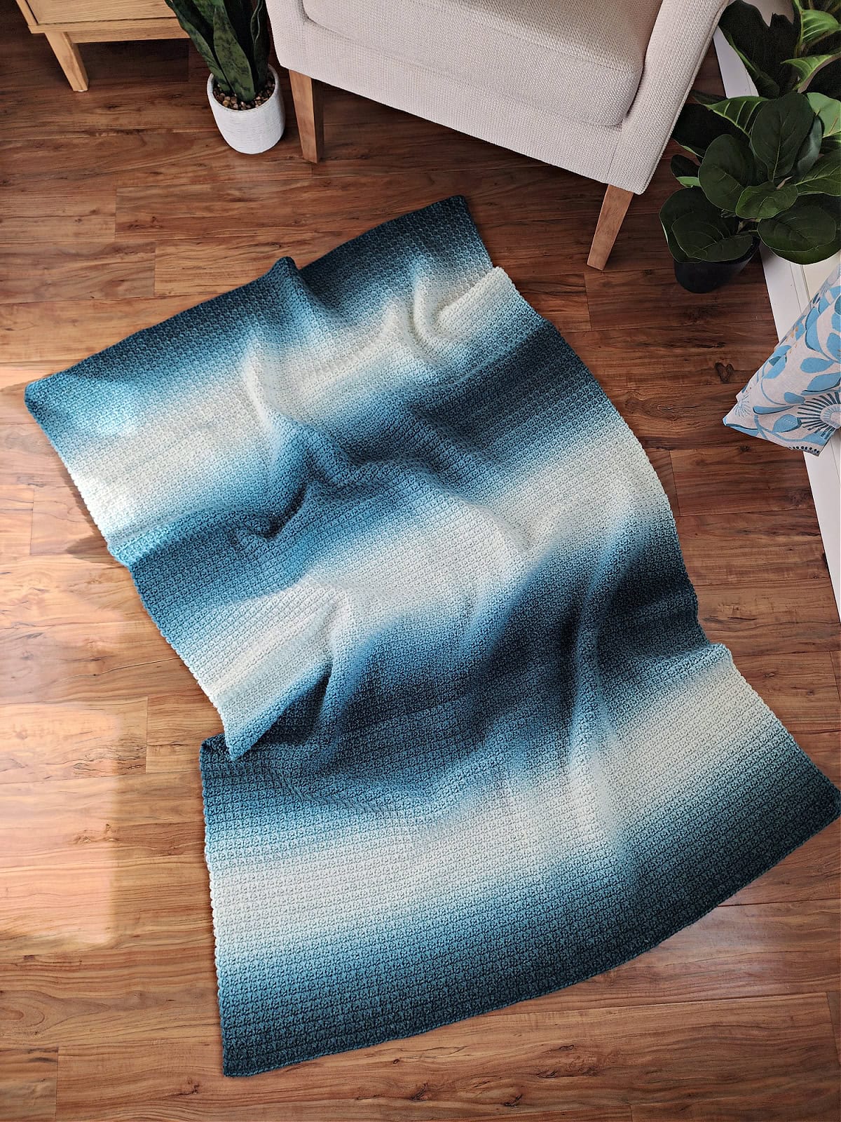 An easy crochet blanket for beginners made with gradient yarn.