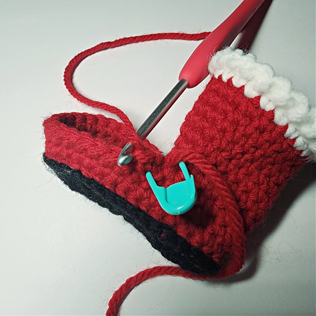 Small crochet Santa boot with the ankle and cuff complete.