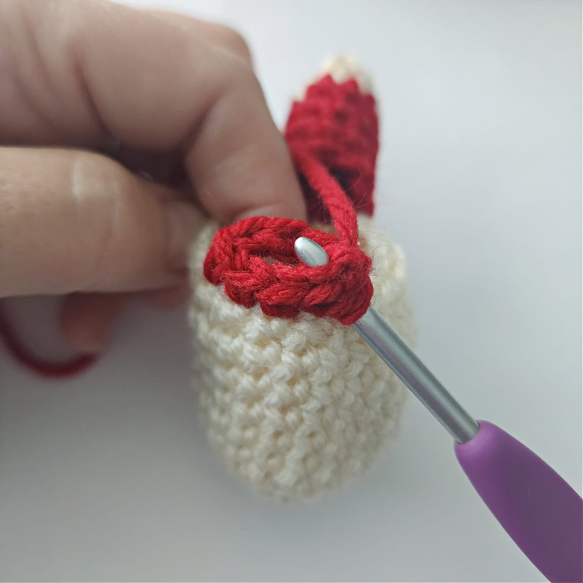 A crochet hook joining to make a circle to begin the crochet arm.