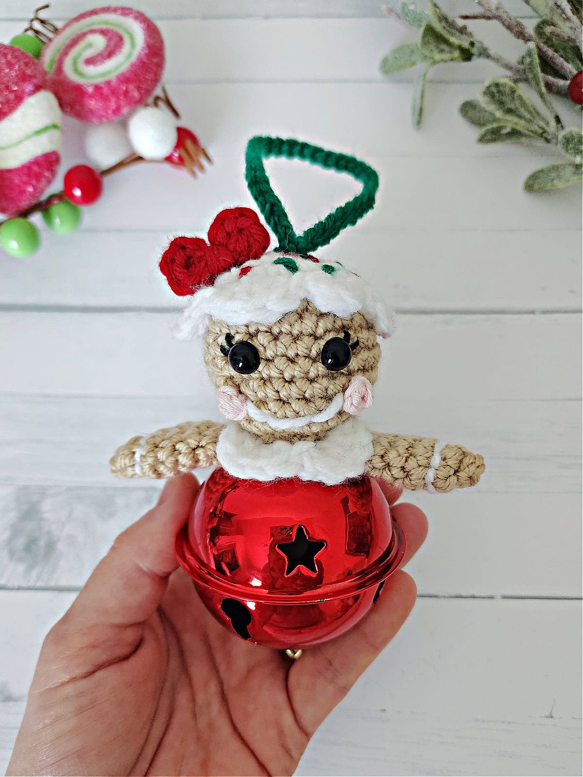 Gingerbread girl crochet ornament with a red boy and icing hair.