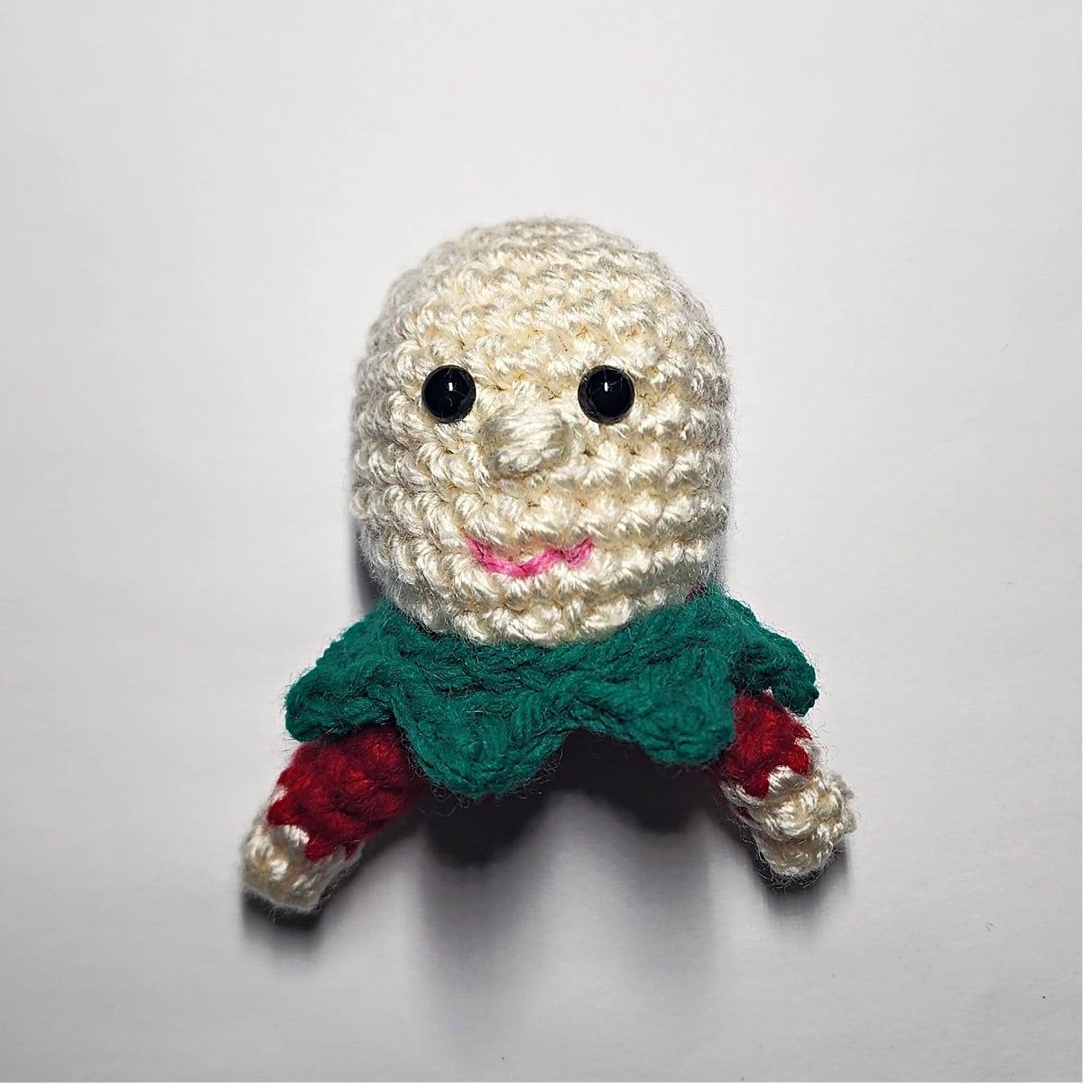 How to embroider a mouth on a small elf amigurumi.