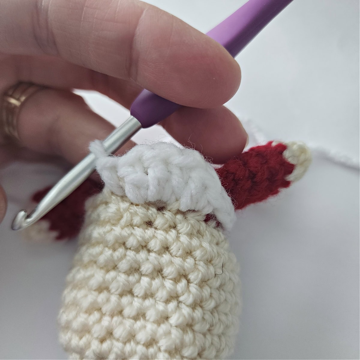 A crochet shell is made to resemble half of the collar on Mrs Claus.