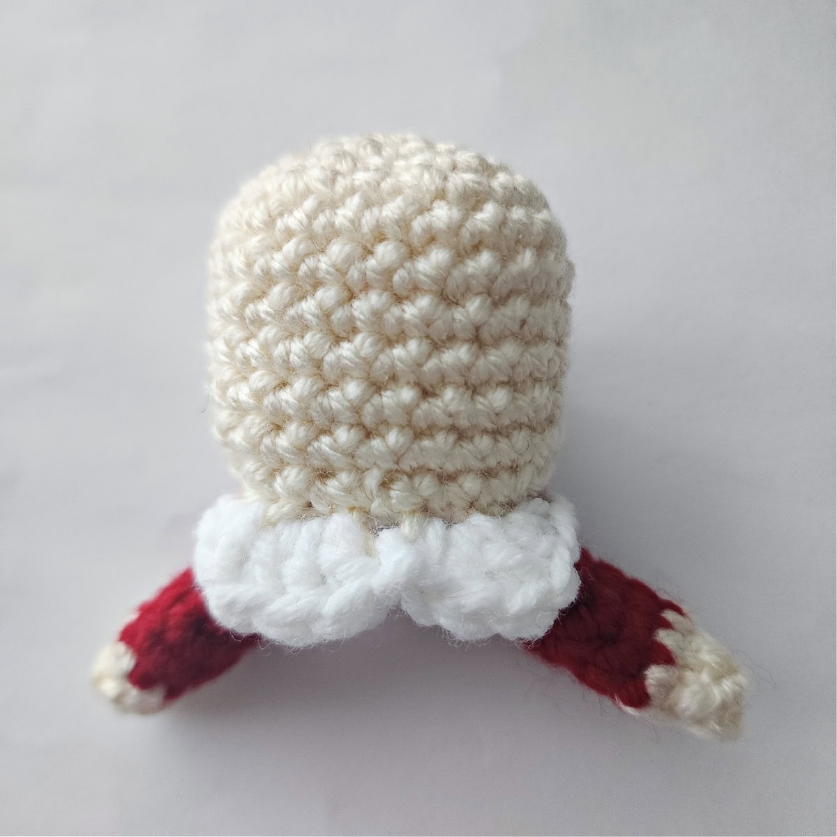 Mrs Claus's crochet collar and arms are attached to the crochet head.