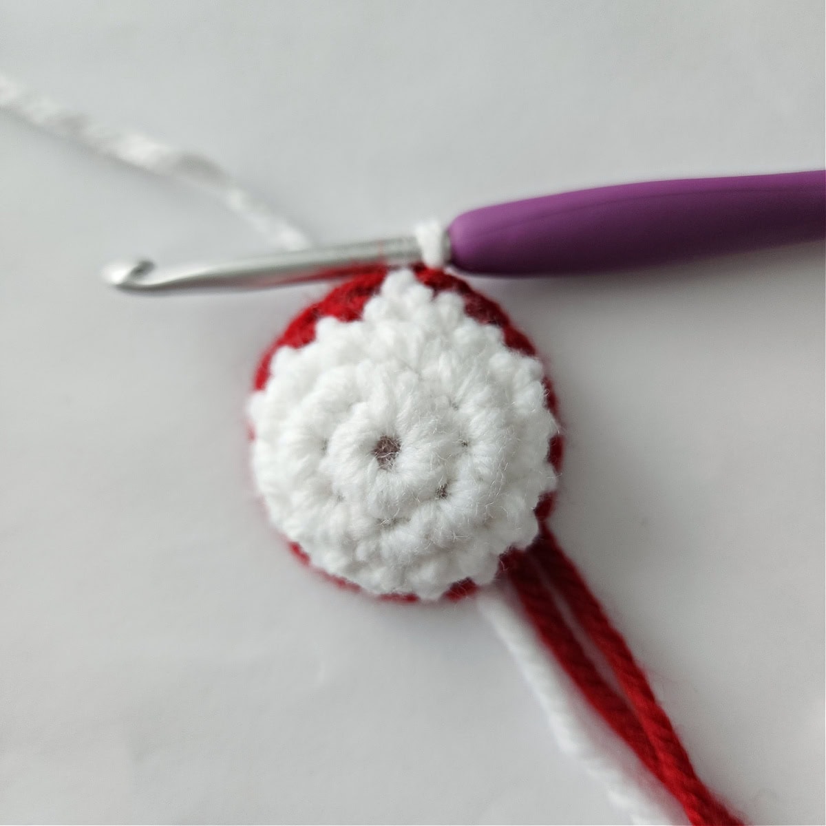 A small crochet bun with a red stripe for the top of Mrs Claus's head.