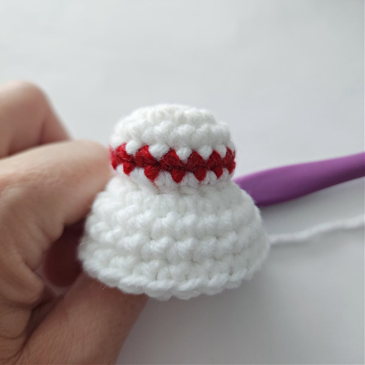 A bun and hair crocheted for a Mrs Claus crochet jingle bell ornament.