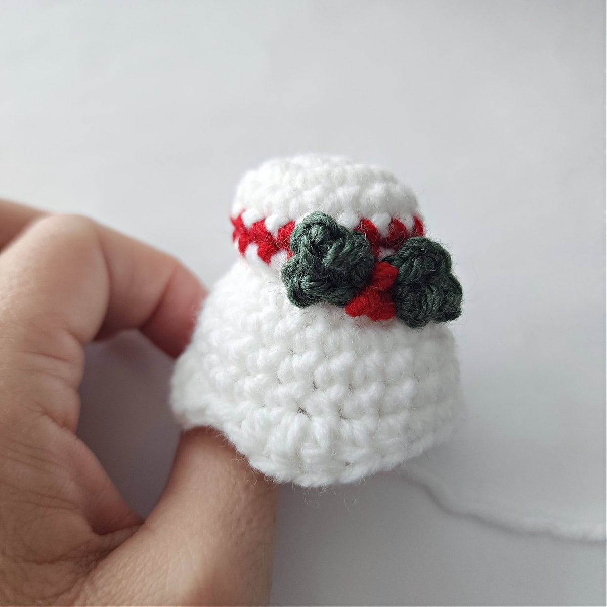 Mrs Claus's crochet hair bun with holly leaves and berries.