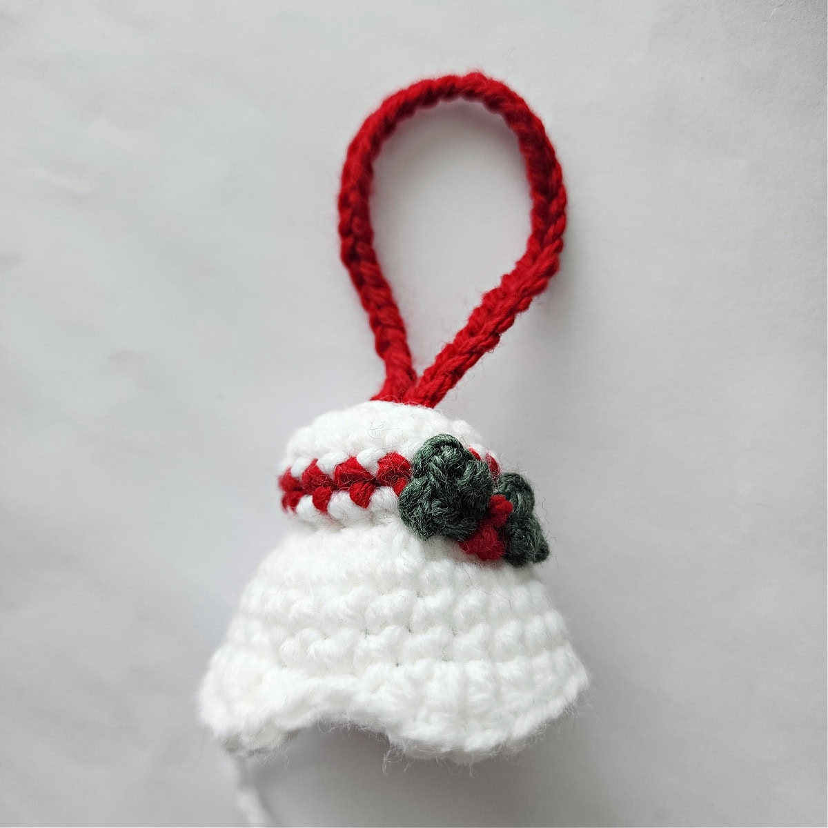 White hair bun for Mrs Claus ornament with holly leaves and berries.