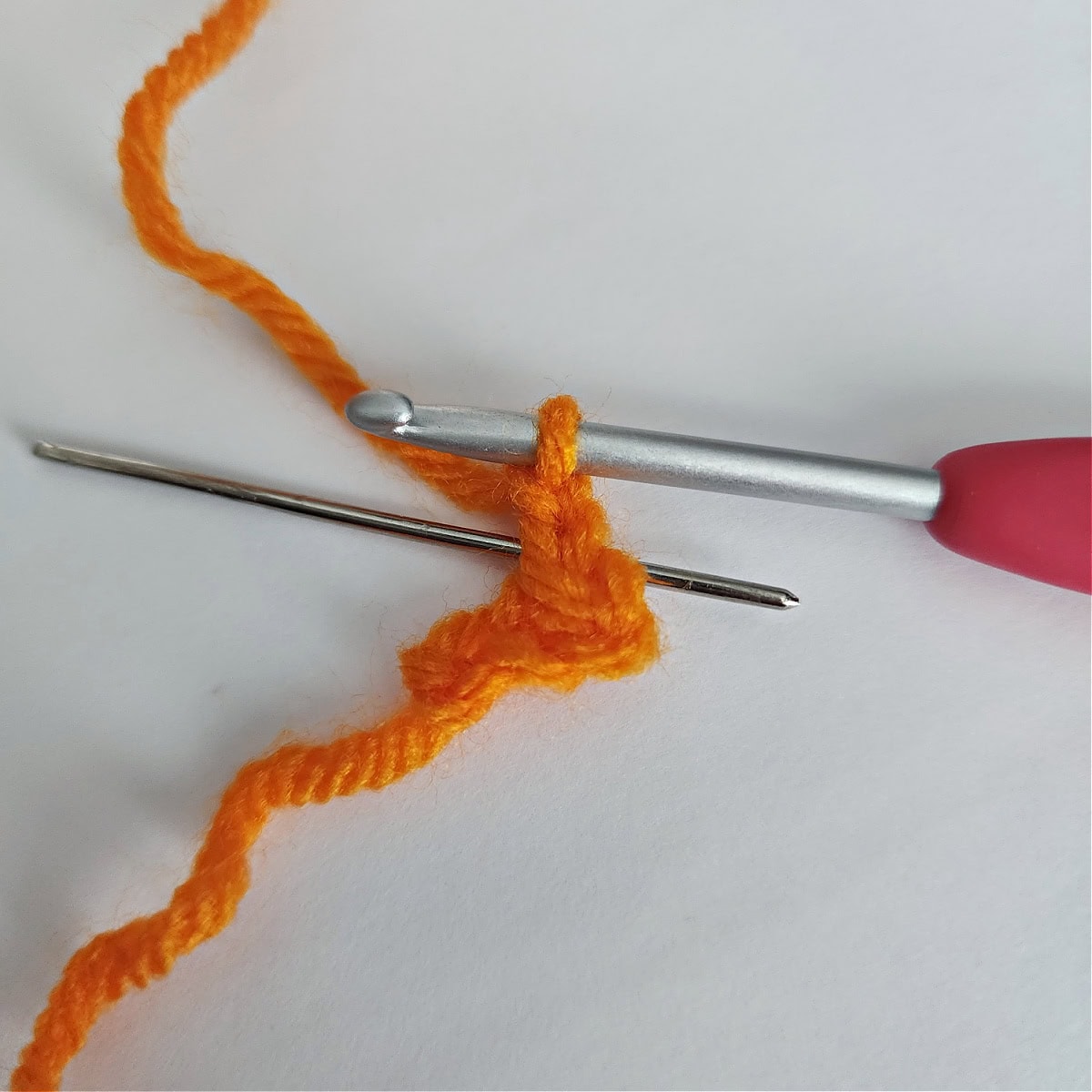 Beginning of an orange crochet beak.