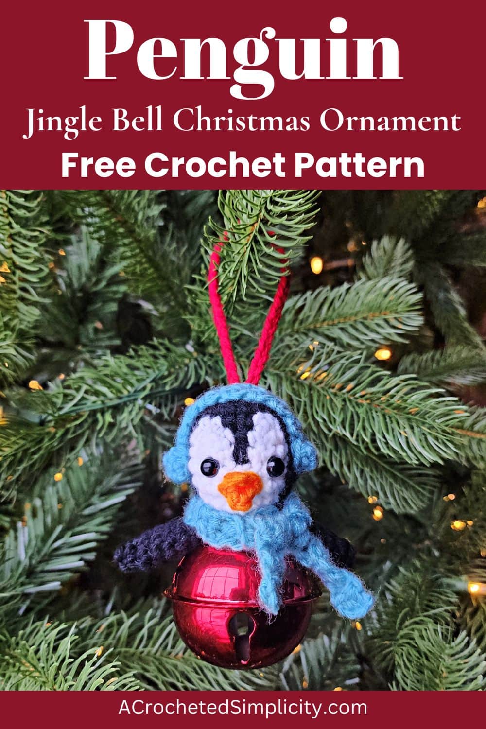 Crochet penguin ornament hanging on a Christmas tree.