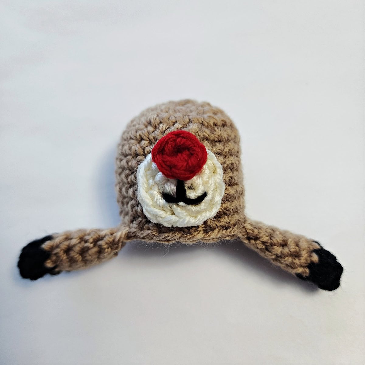 Crochet reindeer head and front legs with hooves.