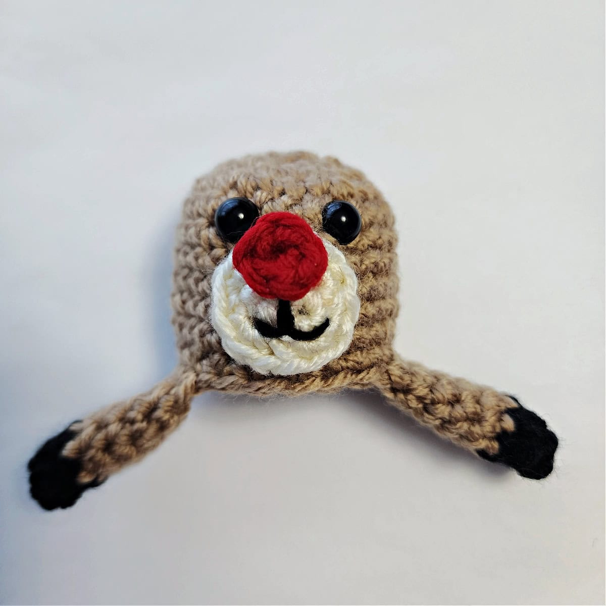 Crochet reindeer head and front legs with hooves and plastic safety eyes.