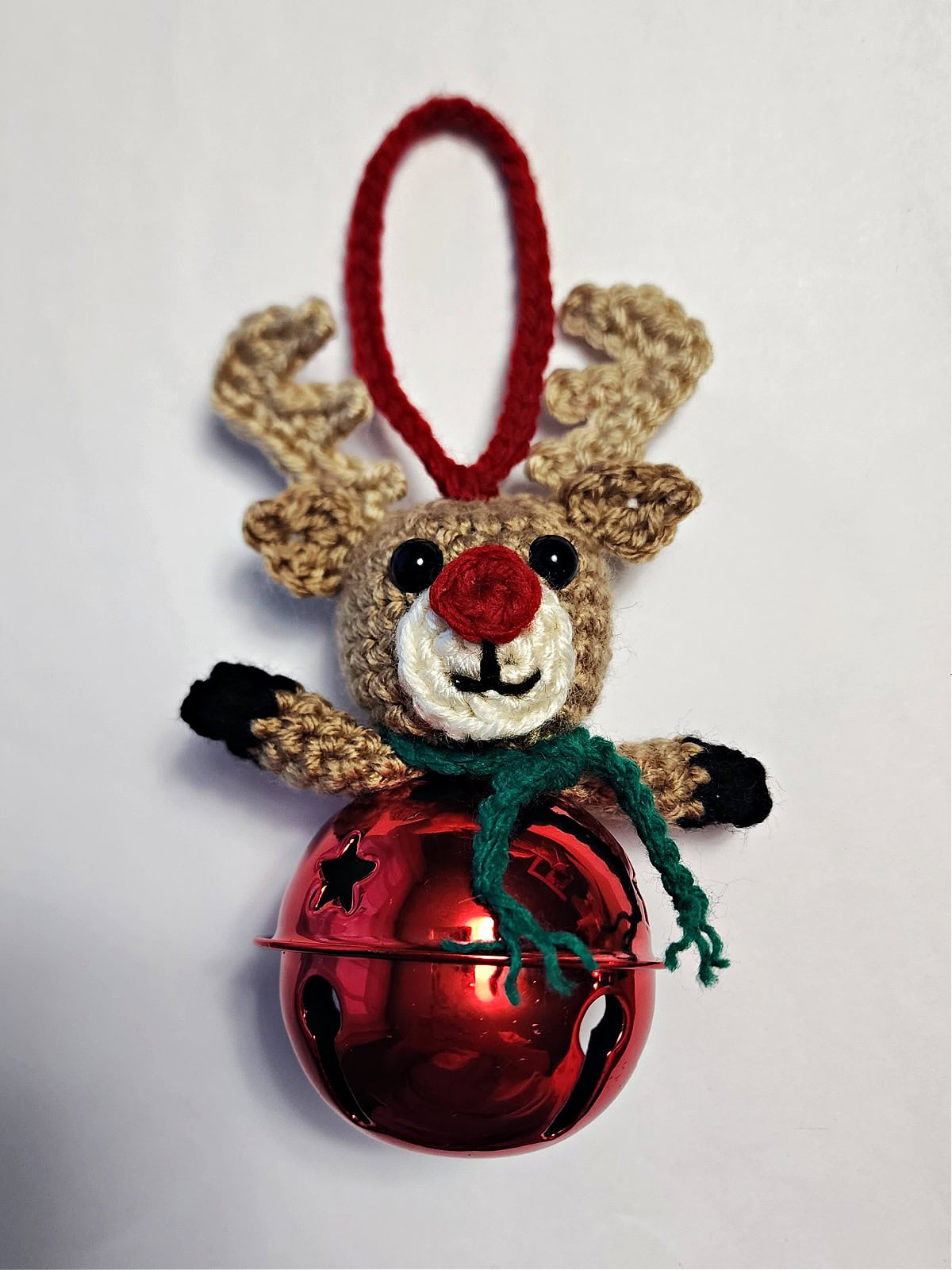 Crochet reindeer jingle bell ornament complete with hanging loop.