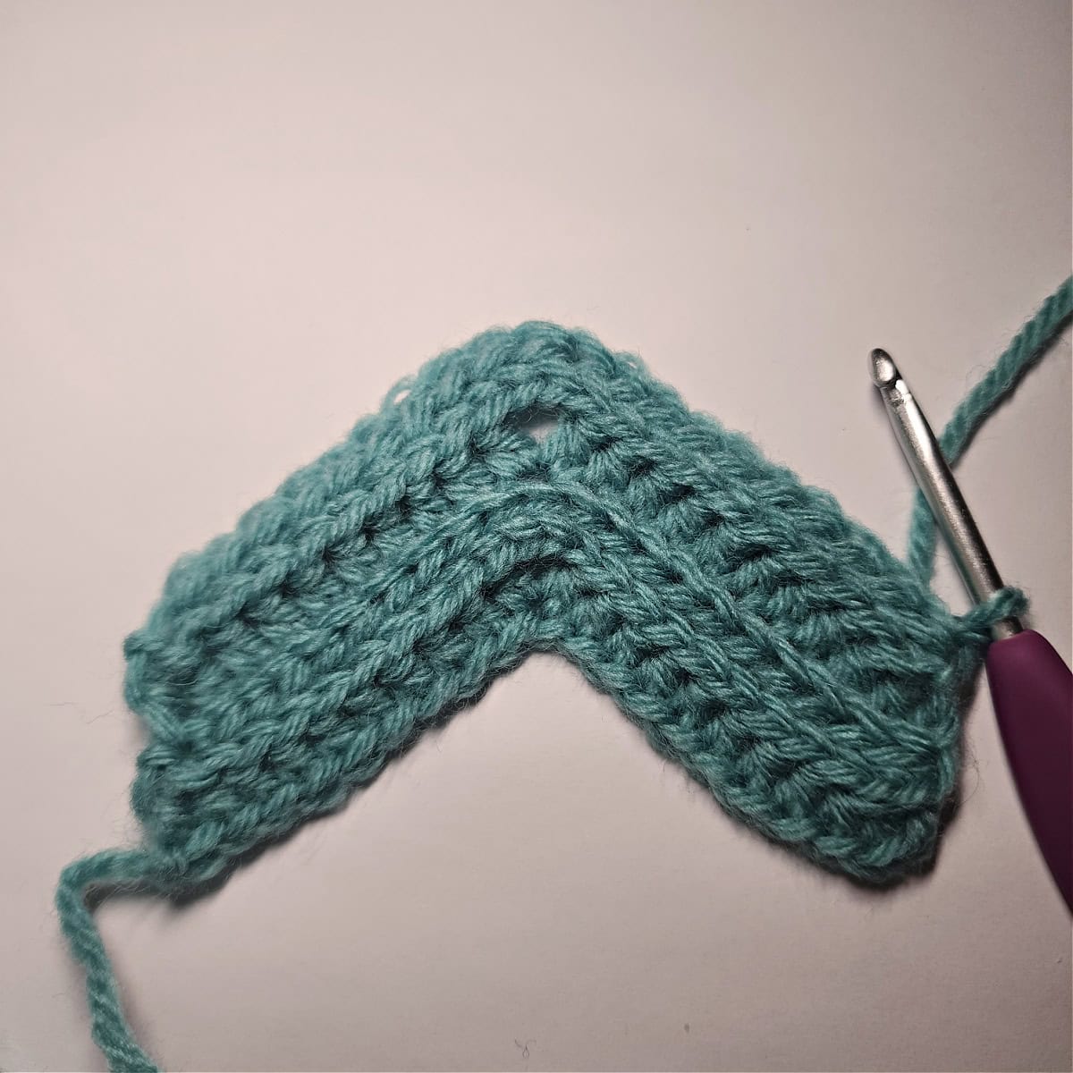 Crochet ear warmer turned to the right side ready to crochet the next row 2 repeat.