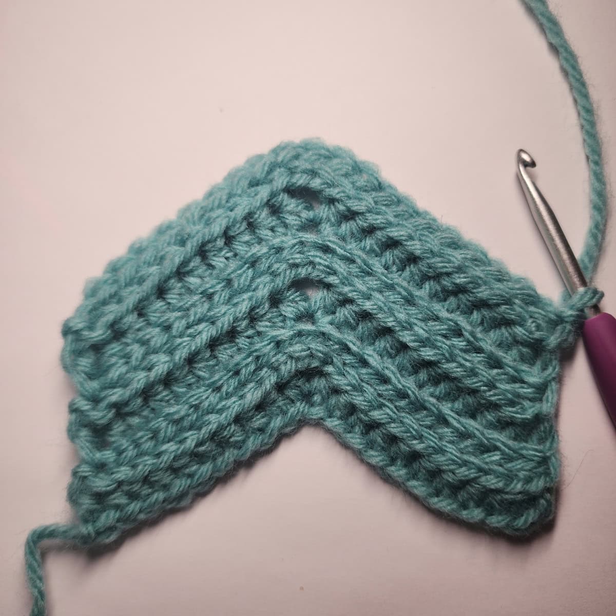 The right side of the crochet ear warmer ready to work row 7.