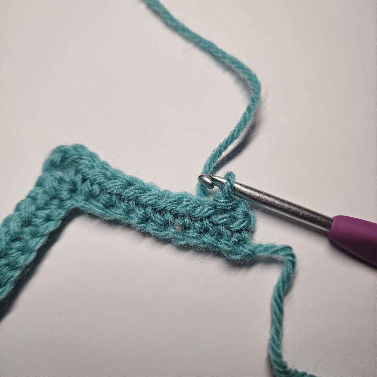 The first slip stitch of row 2 worked into the second stitch of the row.