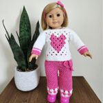 American Girl Doll Kit wearing crochet doll clothes and pink shoes.