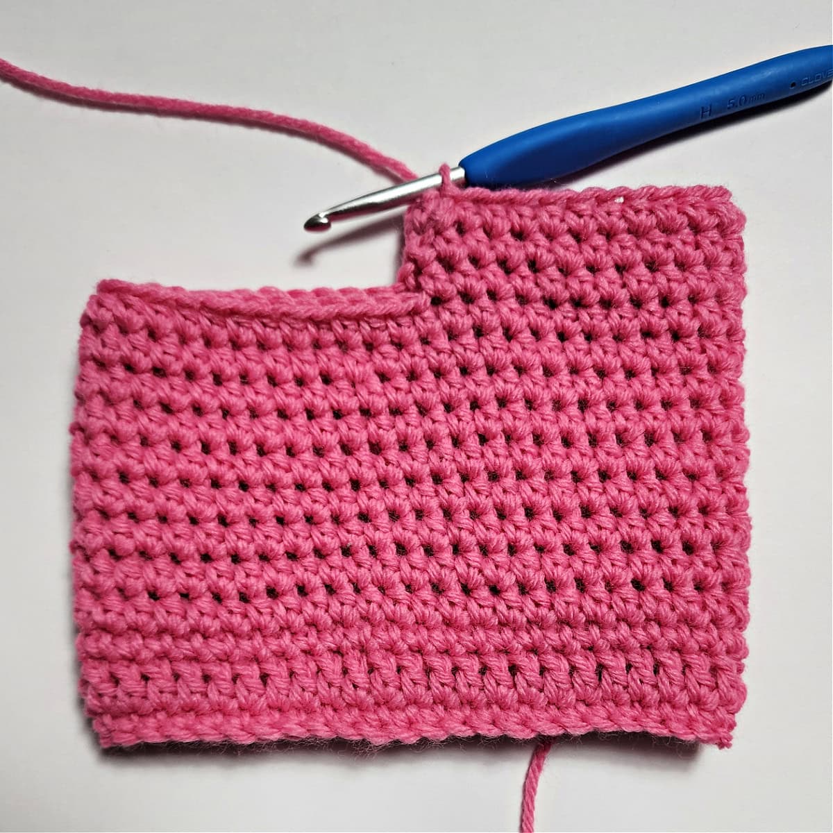 The first leg on a pair of crochet doll pants being crocheted.