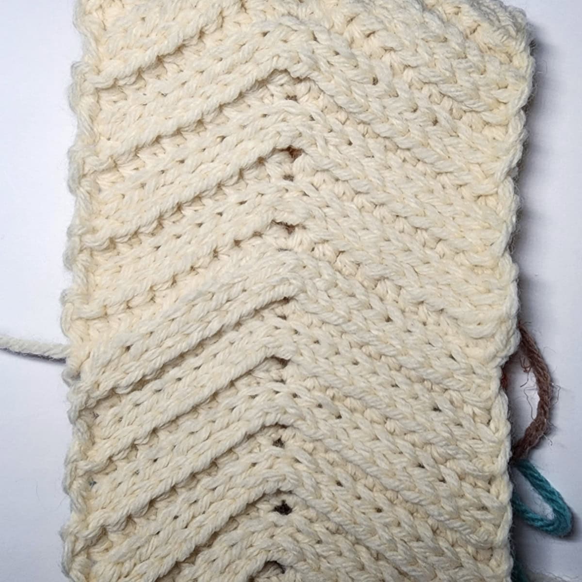 Edges of the crochet ear warmer seamed together.