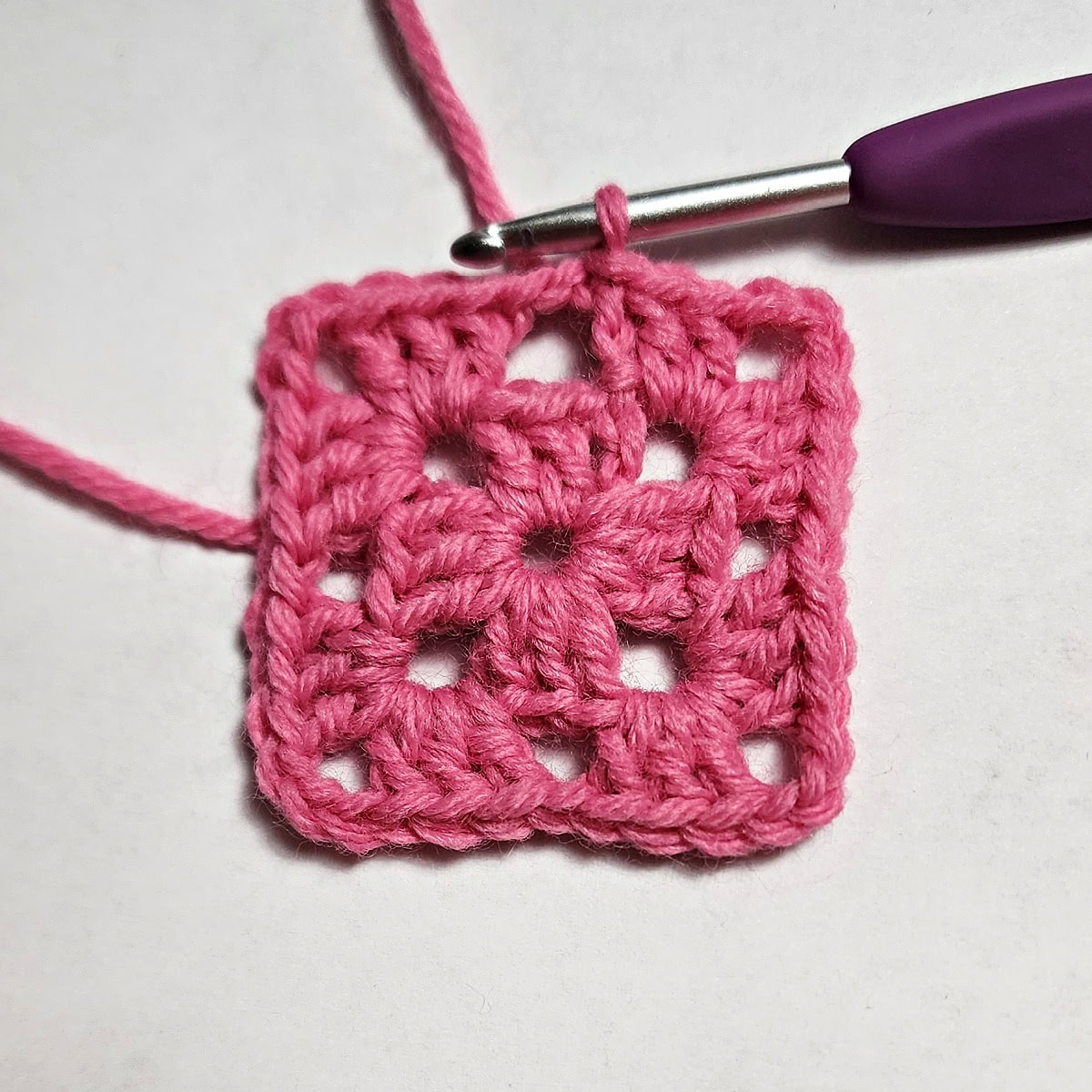 Round two complete of a heart granny square.