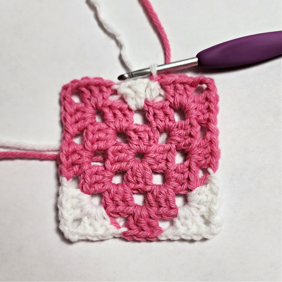 Round three complete of a heart granny square.