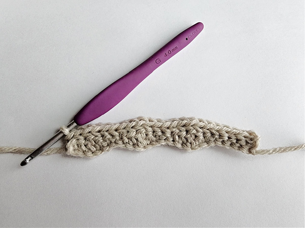 Row 2 of a slipper cuff in a knit-look crochet stitch pattern.